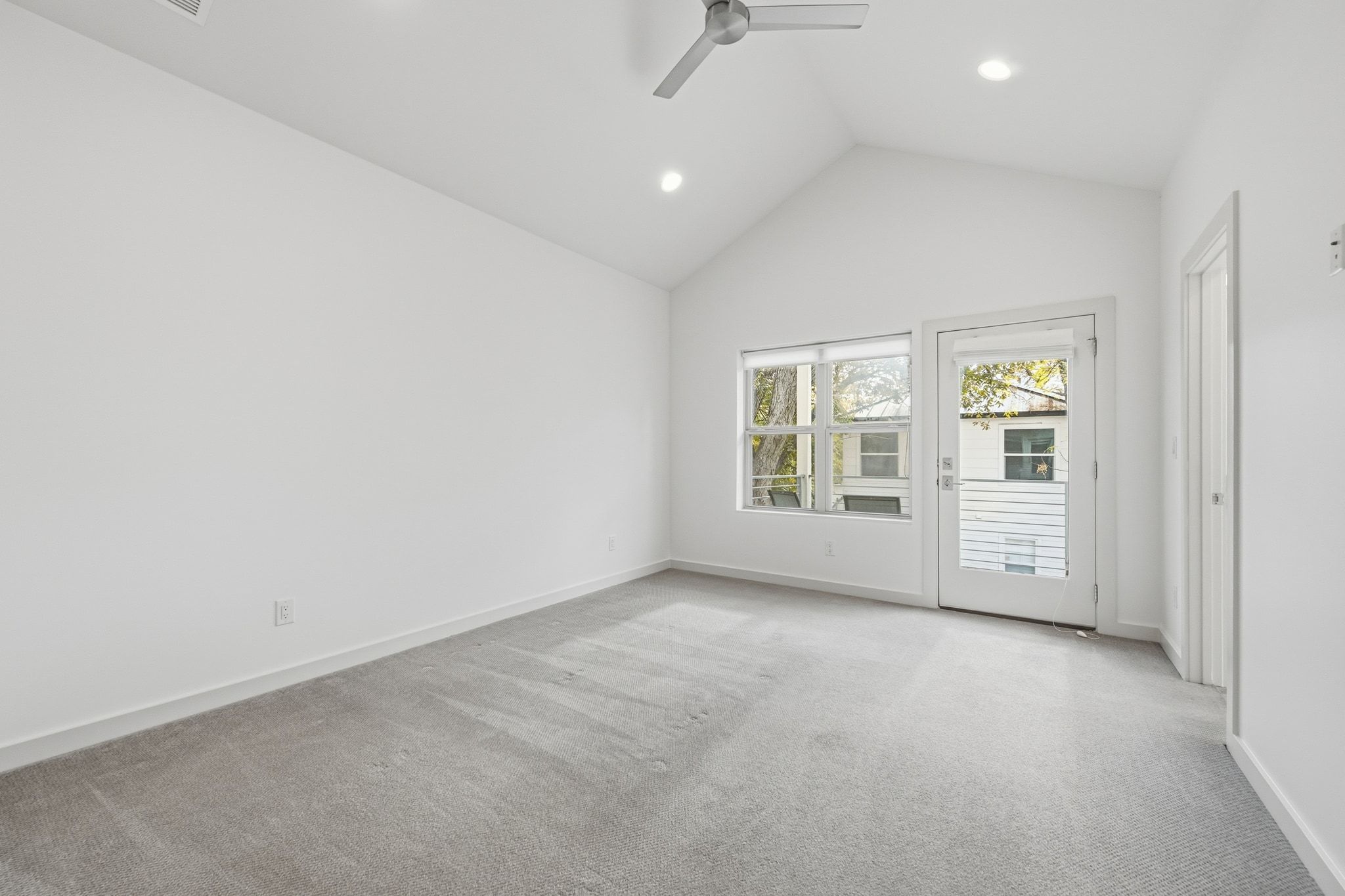 2811 Garwood Street, Unit B Austin, TX 78702 - Photo 17 of 24 Empty room featuring ceiling fan, light carpet, high vaulted ceiling, and recessed lighting