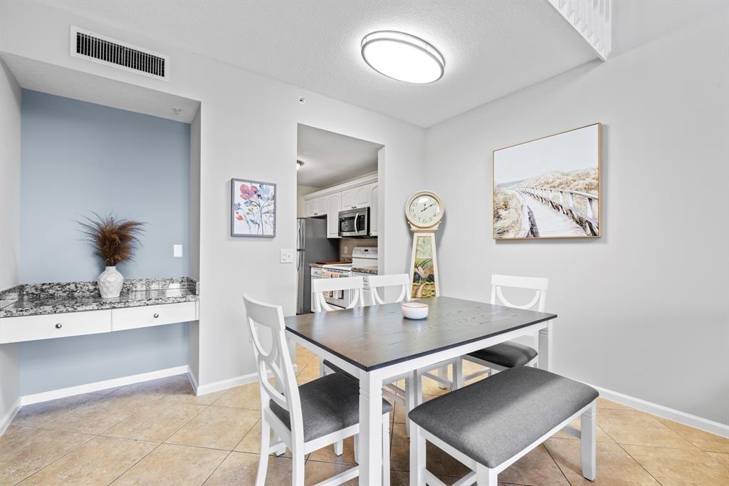 4784 Central Boulevard, Unit 22 Jupiter, FL 33458 - Photo 4 of 18 a view of a dining room with furniture and wooden floor