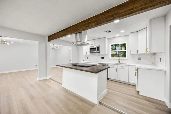a kitchen with stainless steel appliances granite countertop a stove and a sink