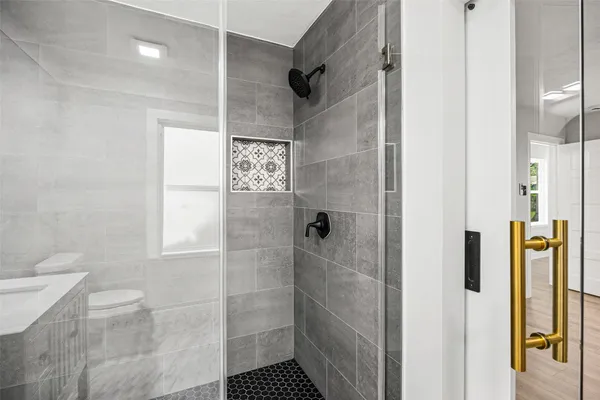 a bathroom with a shower and toilet