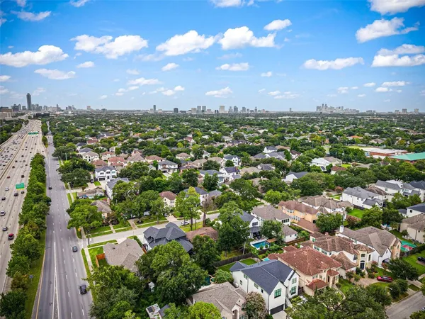 an aerial view of a house with a yard and a large pool