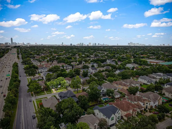 an aerial view of a house with a yard and a pool