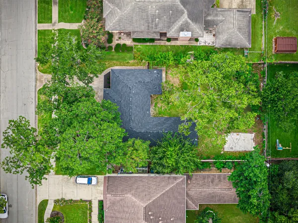 an aerial view of a house with a yard and a large pool
