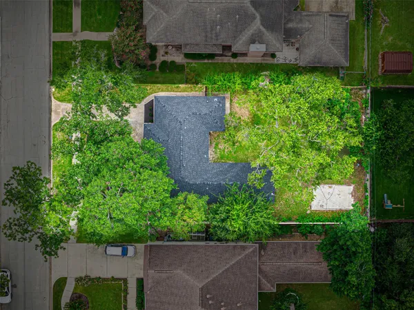 an aerial view of a house with a yard and a pool