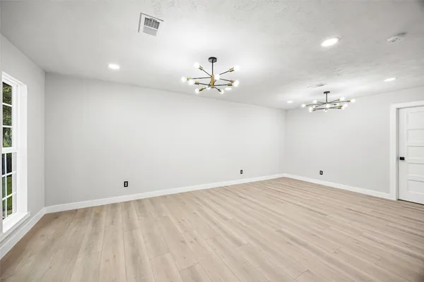 a view of an empty room with a kitchen