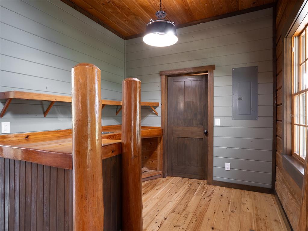 12100 Northwest 110th Avenue Reddick, FL 32686 - Photo 11 of 38 a view of an empty room with wooden floor and a window