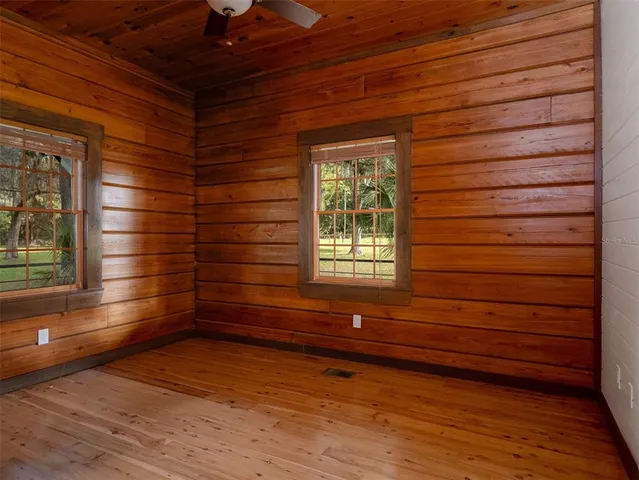 a view of lot of window and wooden floor