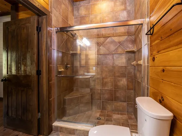 a bathroom with a shower toilet and sink