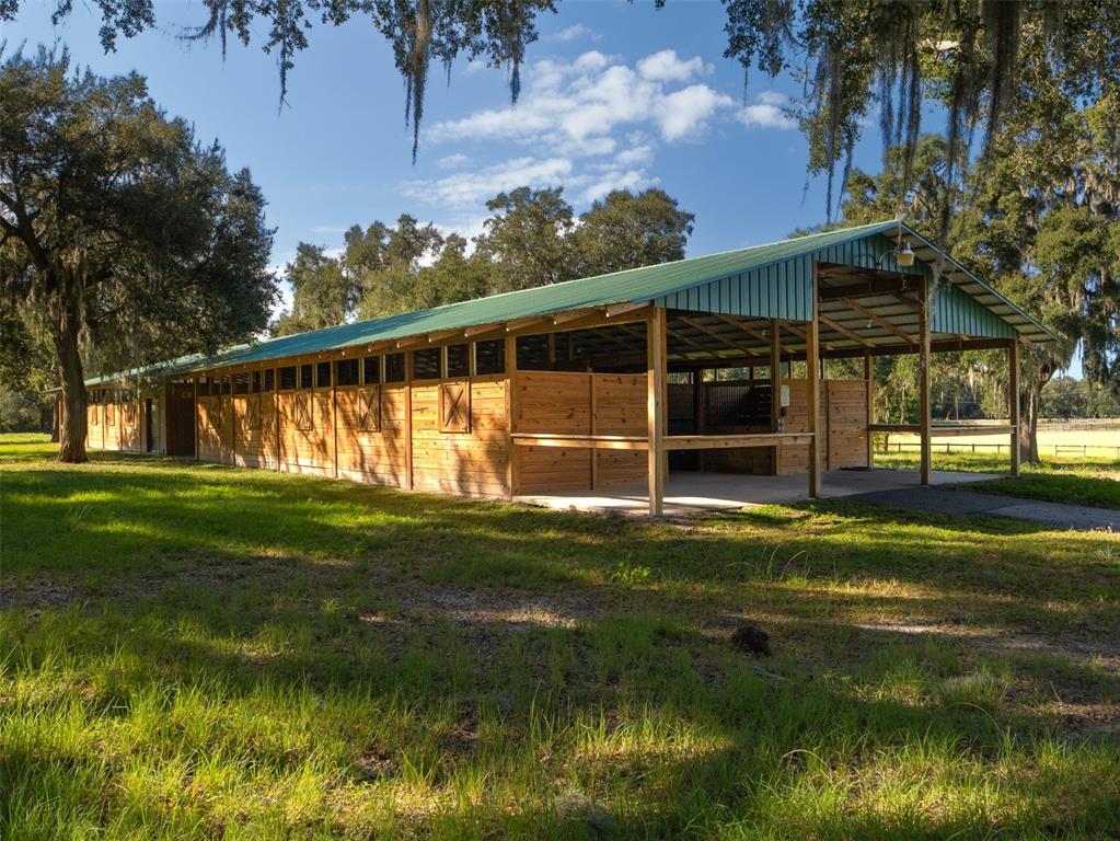 12100 Northwest 110th Avenue Reddick, FL 32686 - Photo 27 of 38 a swimming pool with outdoor seating and yard