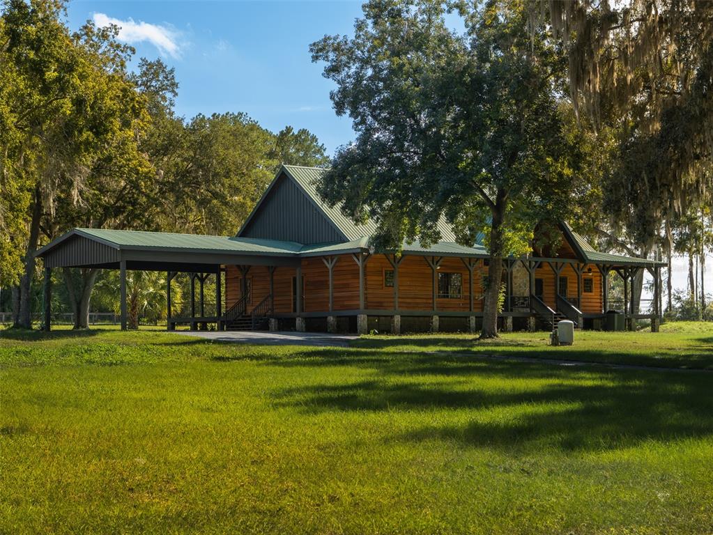 12100 Northwest 110th Avenue Reddick, FL 32686 - Photo 3 of 38 a front view of a house with a yard