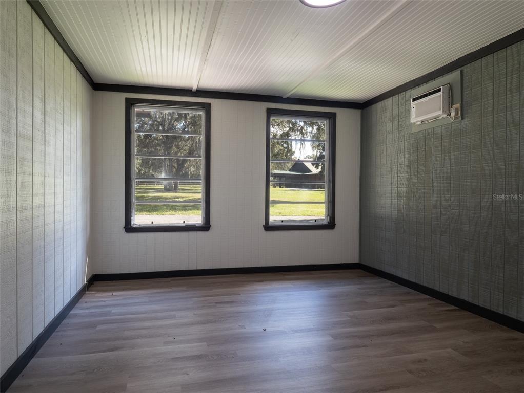 12100 Northwest 110th Avenue Reddick, FL 32686 - Photo 32 of 38 an empty room with wooden floor and windows