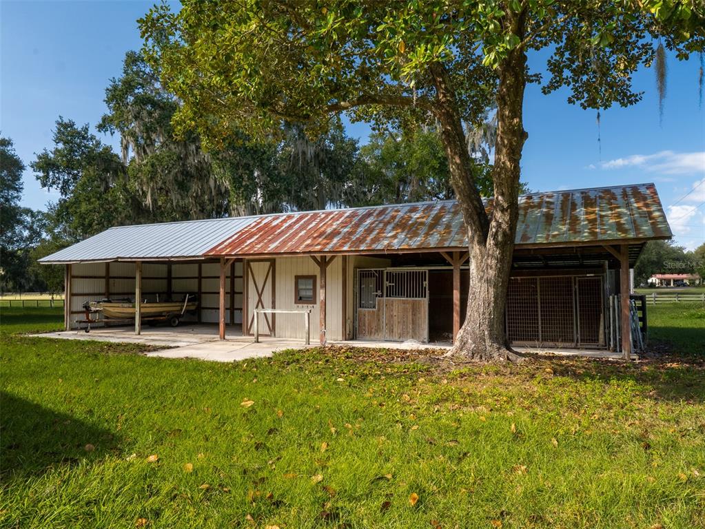 12100 Northwest 110th Avenue Reddick, FL 32686 - Photo 35 of 38 a front view of a house with a yard