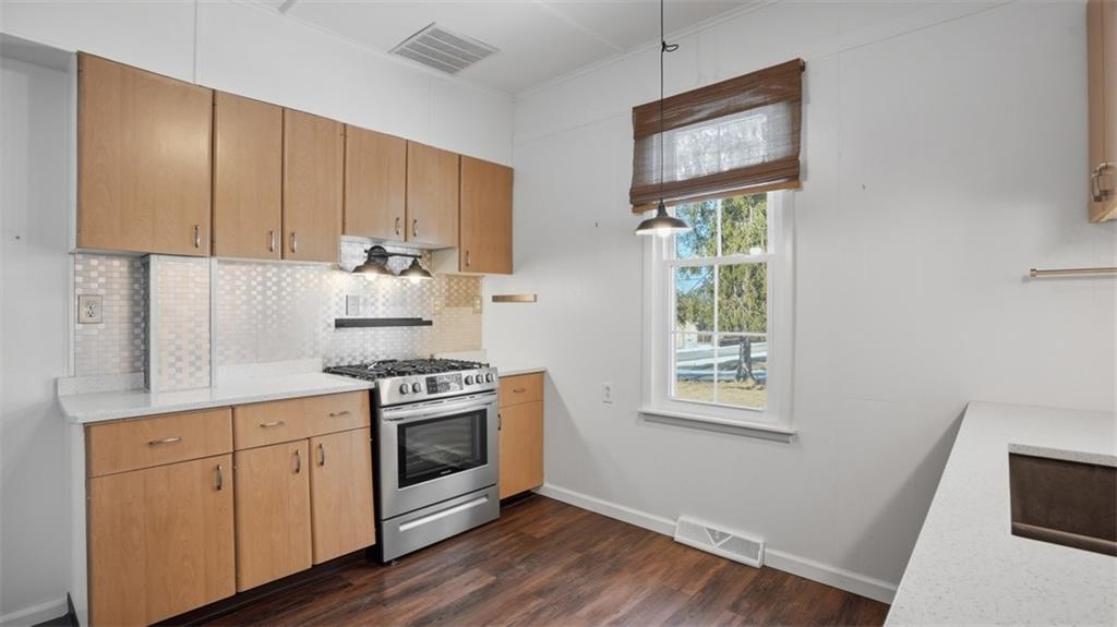 1105 Linden Street Monaca, PA 15061 - Photo 28 of 45 a kitchen with cabinets stainless steel appliances and wooden floor