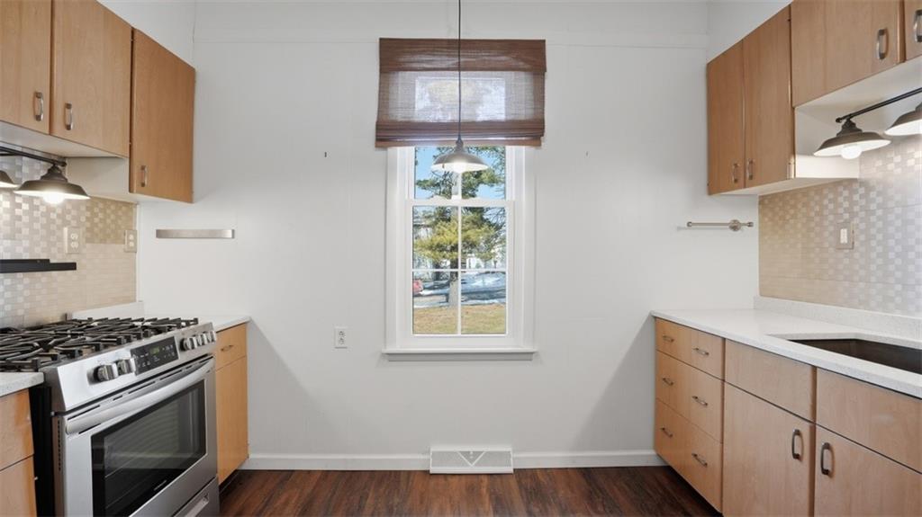 1105 Linden Street Monaca, PA 15061 - Photo 29 of 45 a kitchen with wooden cabinets and a stove top oven