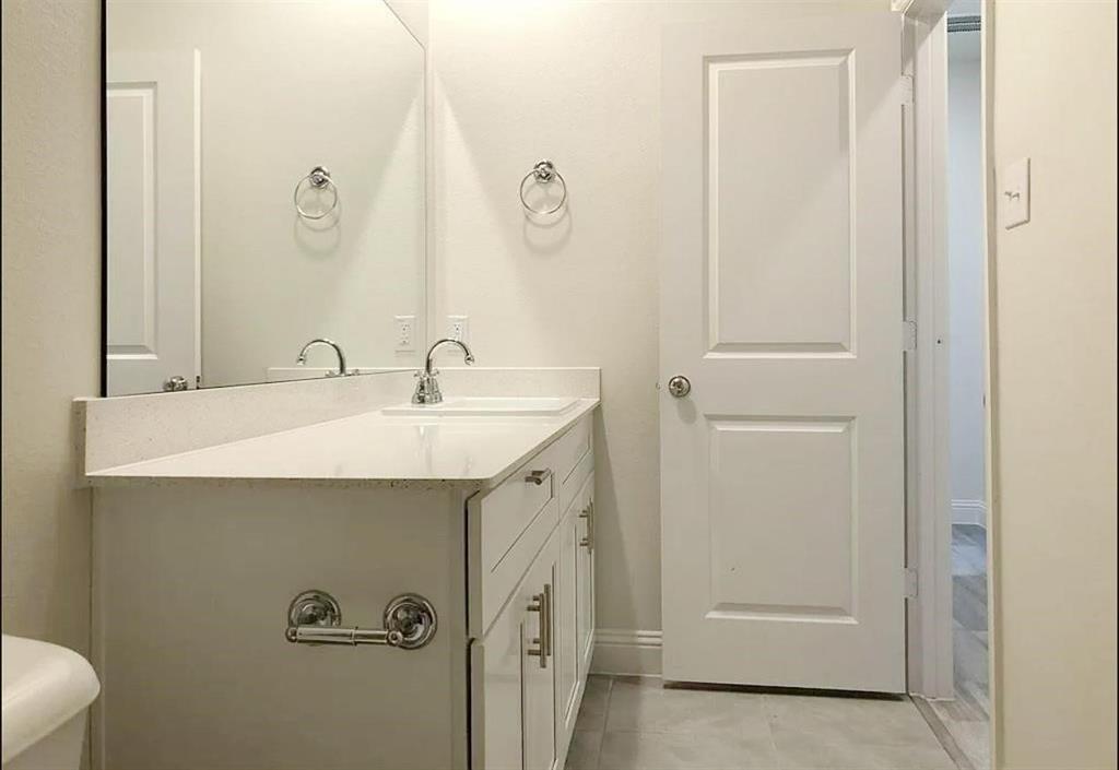 3817 Bennett Trail Celina, TX 75009 - Photo 13 of 22 a bathroom with a sink and mirror with toilet