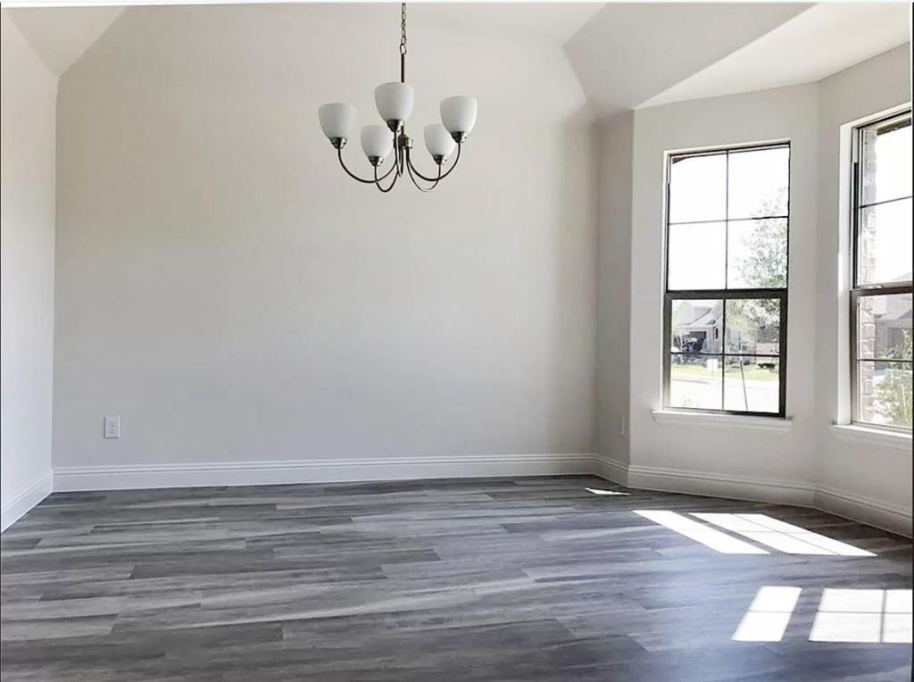 3817 Bennett Trail Celina, TX 75009 - Photo 2 of 22 a view of an empty room with wooden floor and window