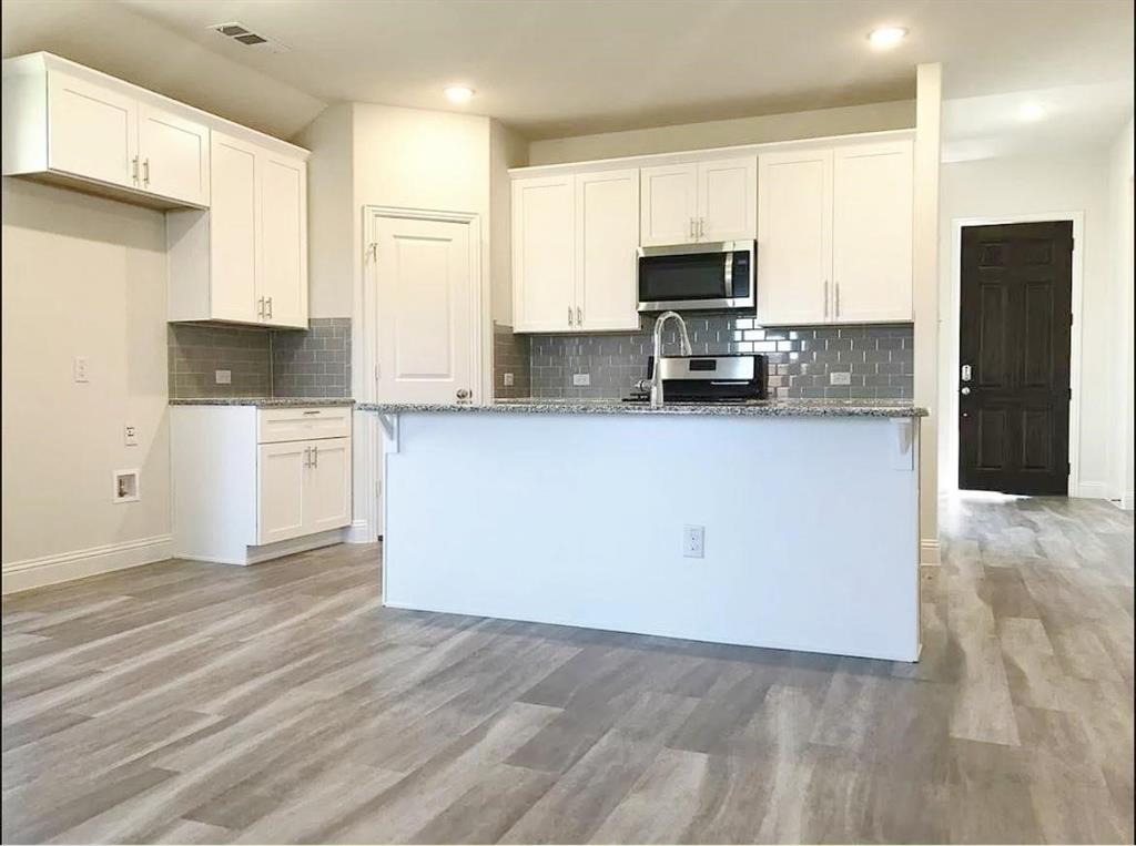 3817 Bennett Trail Celina, TX 75009 - Photo 3 of 22 a kitchen with stainless steel appliances a refrigerator sink and microwave