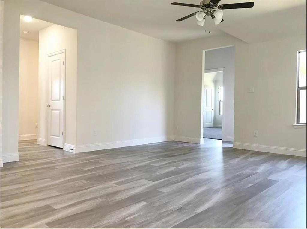 3817 Bennett Trail Celina, TX 75009 - Photo 7 of 22 a view of an empty room with a window and wooden floor