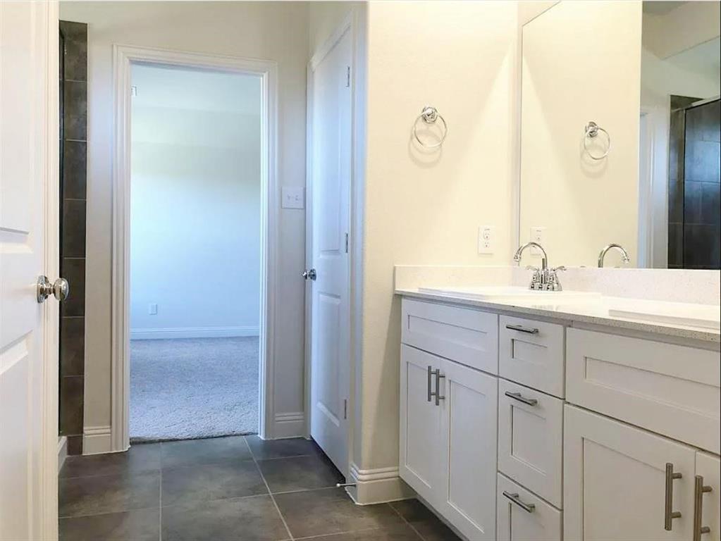 3817 Bennett Trail Celina, TX 75009 - Photo 9 of 22 a bathroom with a double vanity sink and a mirror