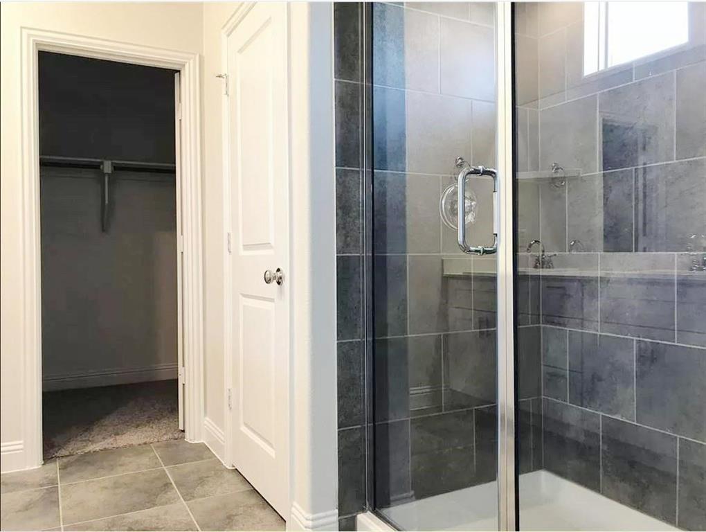 3817 Bennett Trail Celina, TX 75009 - Photo 10 of 22 a bathroom with a glass shower door