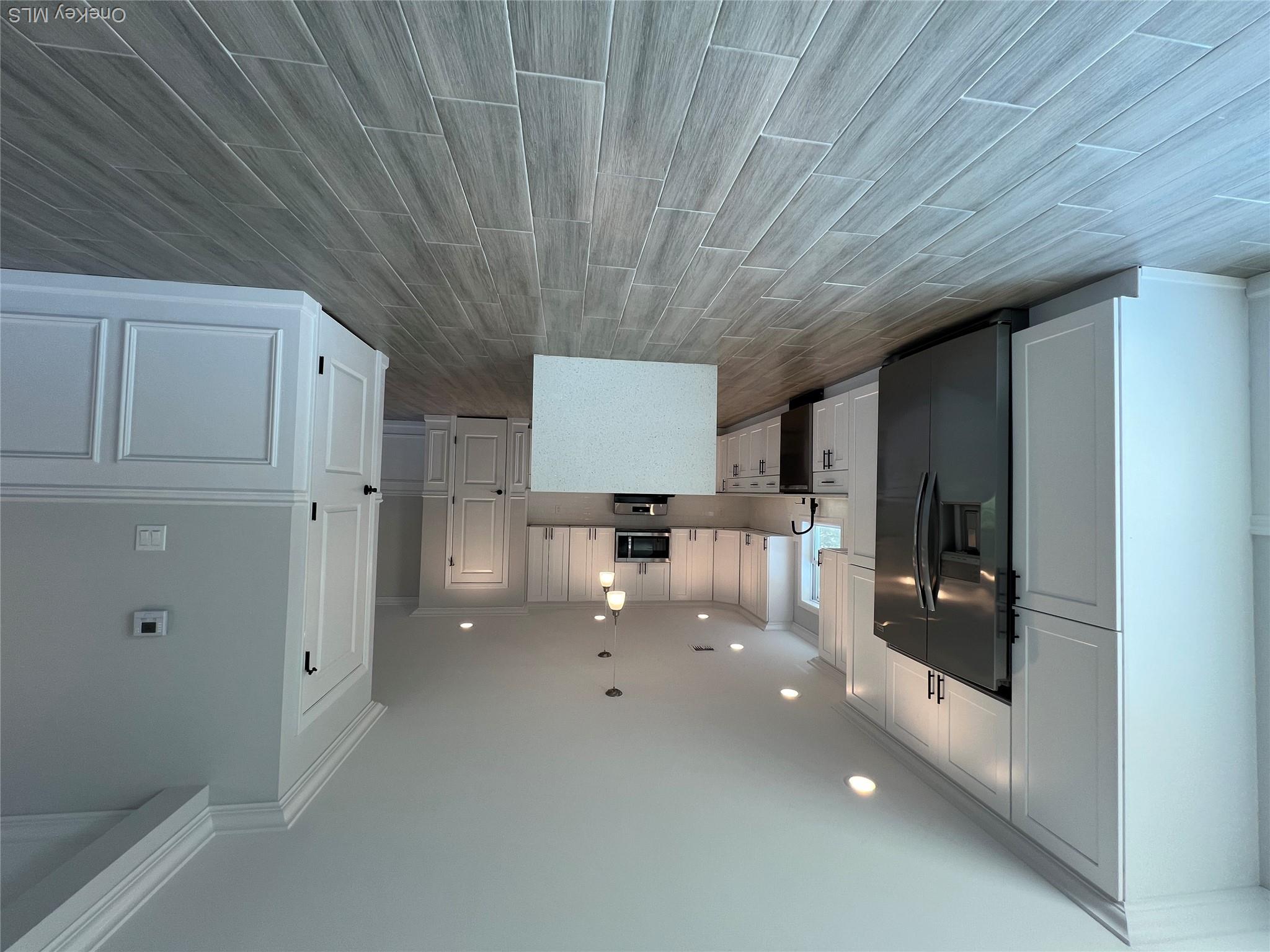 35 Babylon Road Mastic Beach, NY 11951 - Photo 6 of 19 a view of a kitchen with wooden floor and electronic appliances