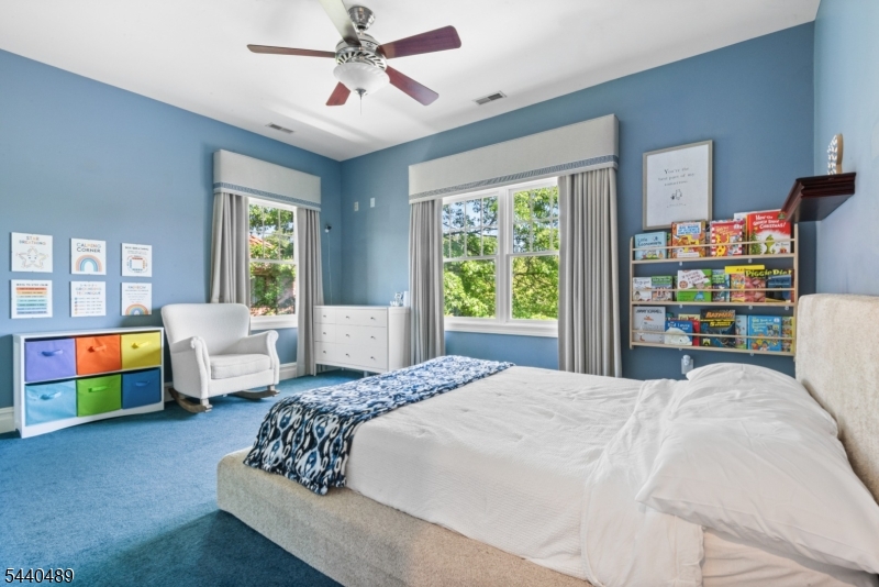 99 East Lindsley Road Cedar Grove, NJ 07009 - Photo 29 of 41 a bedroom with a bed couch and window