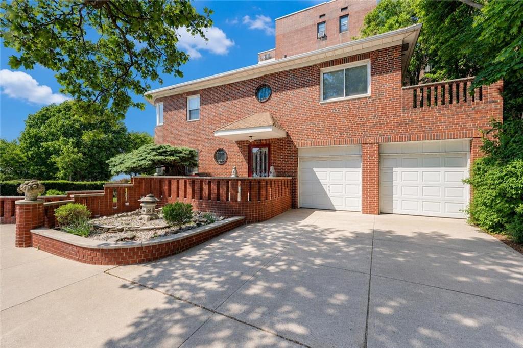 1 Bay Ridge Parkway Brooklyn, NY 11209 - Photo 2 of 38 a front view of a house with a yard and garage
