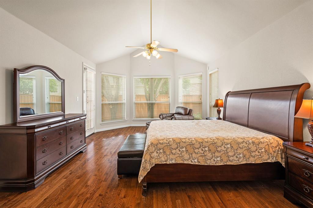 2012 Burnside Drive Allen, TX 75013 - Photo 16 of 40 a bedroom with a large bed and wooden floor