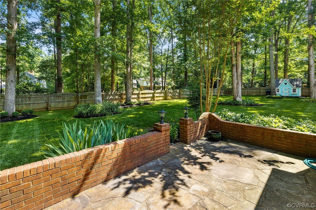 2731 Arrandell Road Midlothian, VA 23113 - Photo 26 of 30 a view of a garden with a bench in a garden