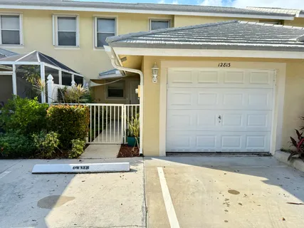 a view of a house with a wooden fence