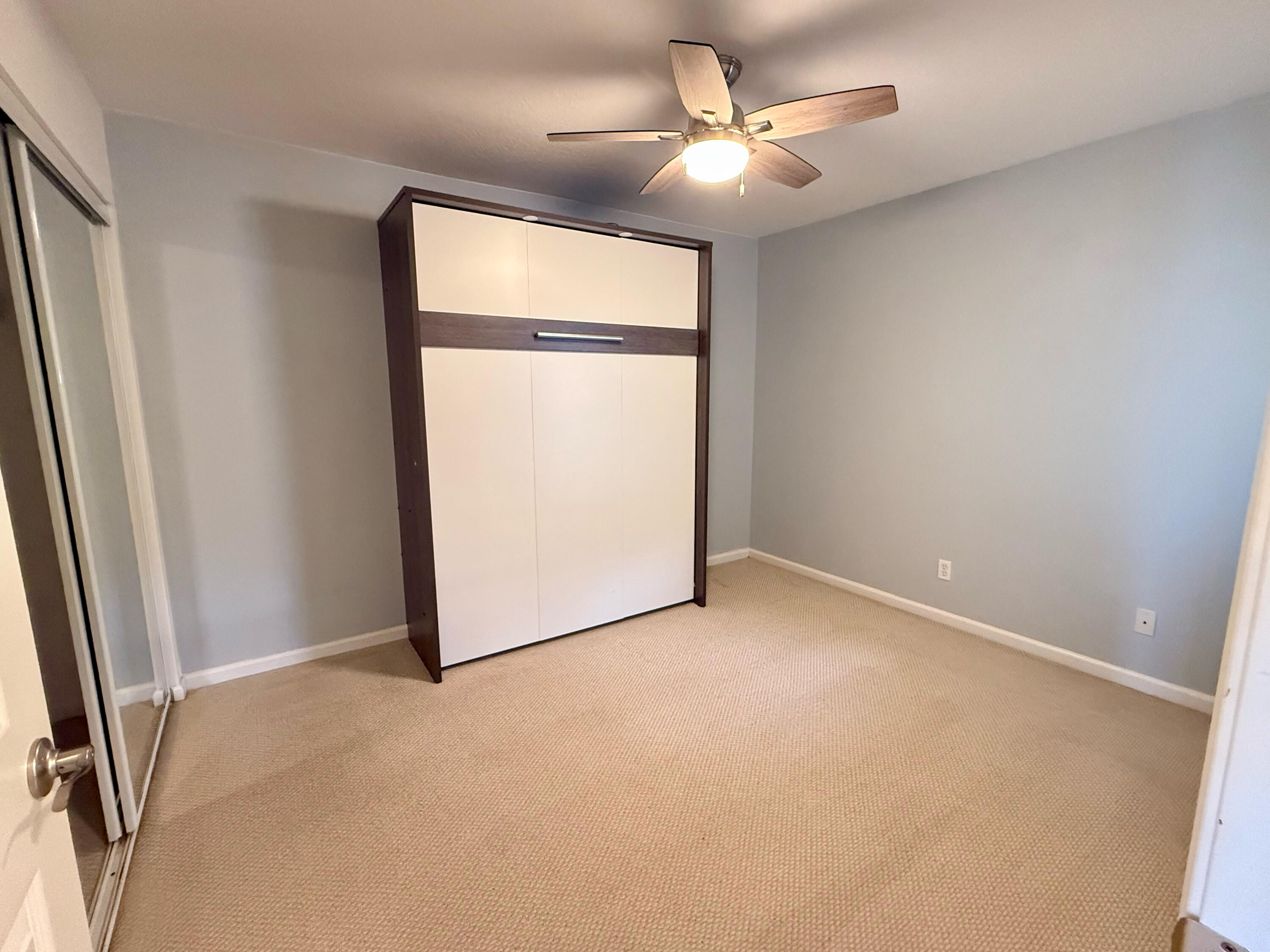 12813 Woodmill Drive Palm Beach Gardens, FL 33418 - Photo 12 of 30 an empty room with a ceiling fan and a window