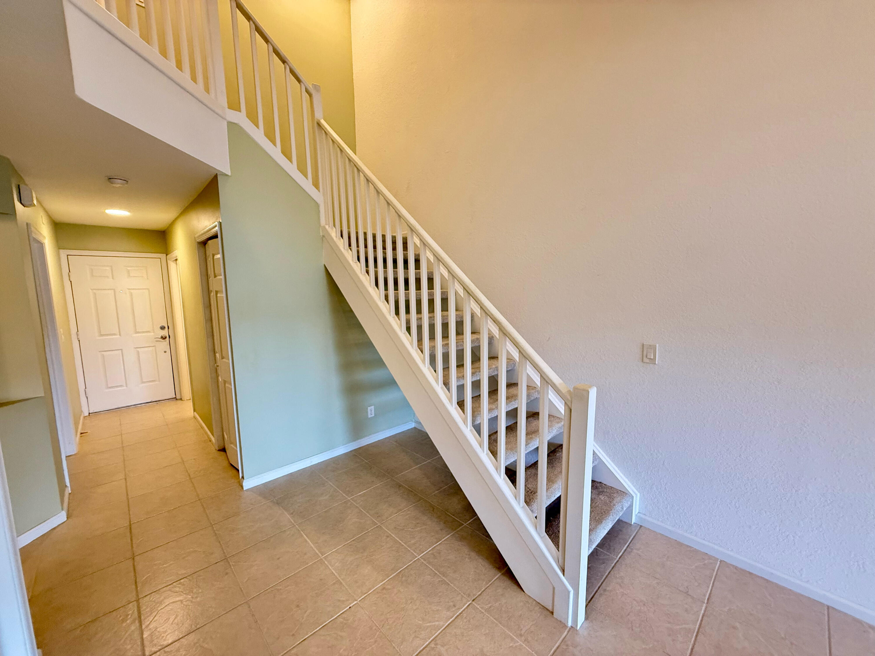 12813 Woodmill Drive Palm Beach Gardens, FL 33418 - Photo 19 of 30 a view of a hallway with staircase