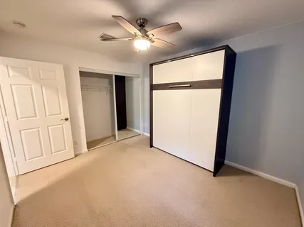 an empty room with windows and closet