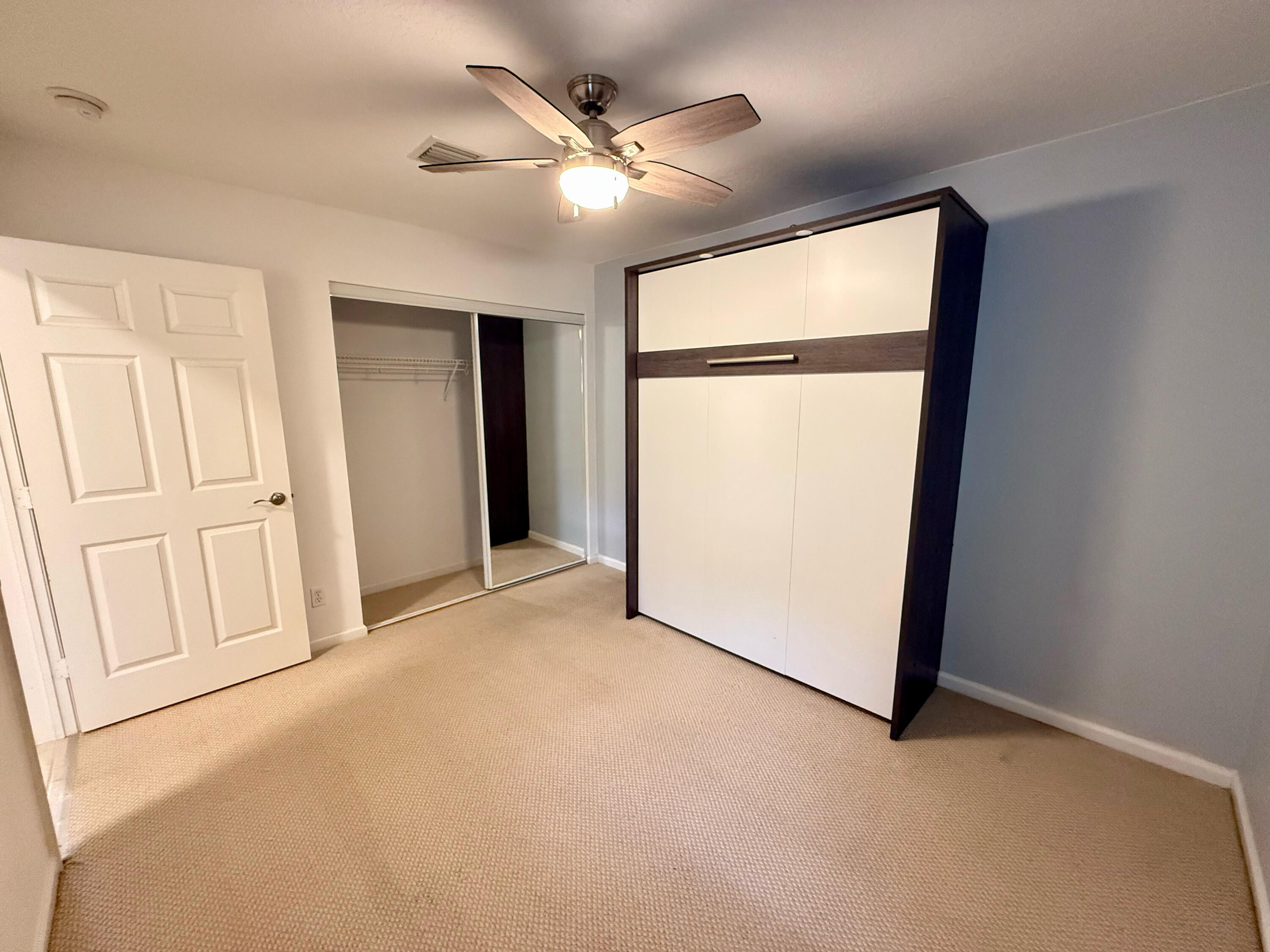 12813 Woodmill Drive Palm Beach Gardens, FL 33418 - Photo 20 of 30 an empty room with windows and closet