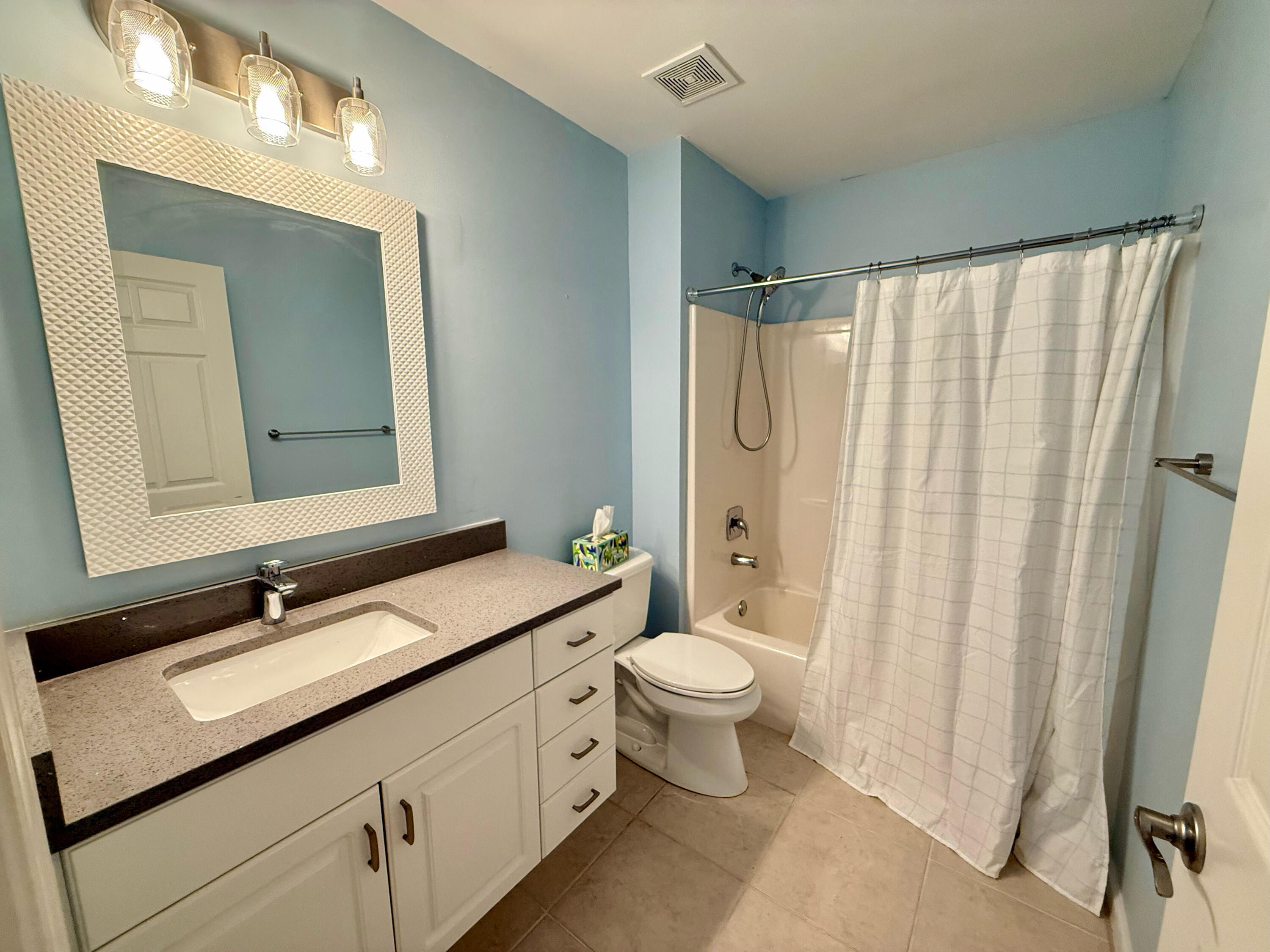 12813 Woodmill Drive Palm Beach Gardens, FL 33418 - Photo 22 of 30 a bathroom with a double vanity sink toilet mirror and shower
