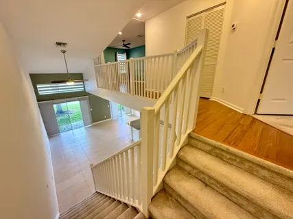 a view of entryway and hall with wooden floor