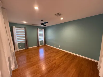 a view of empty room with wooden floor and fireplace