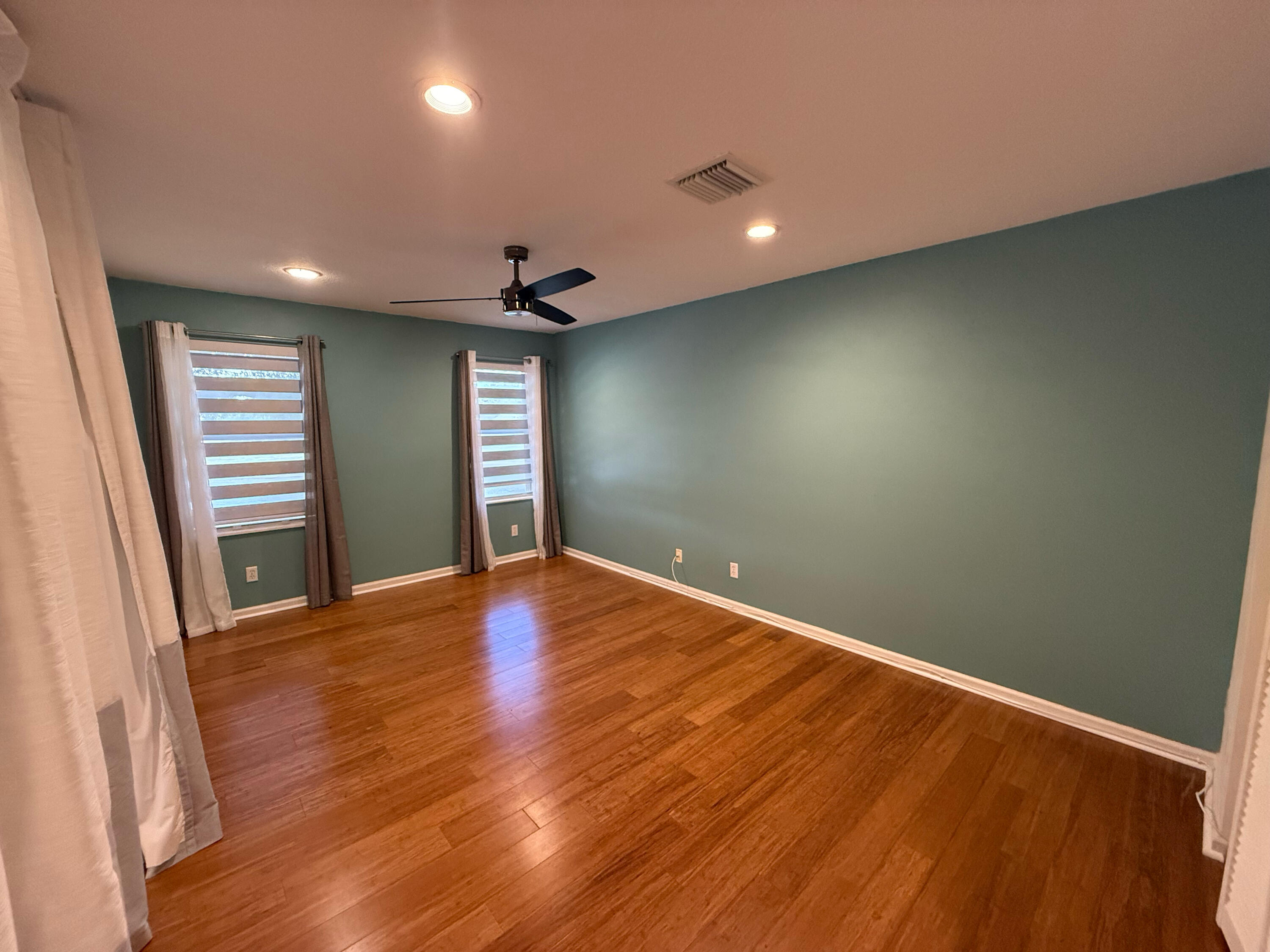 12813 Woodmill Drive Palm Beach Gardens, FL 33418 - Photo 27 of 30 a view of empty room with wooden floor and fireplace