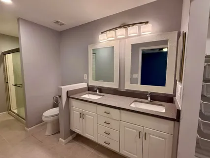 a bathroom with a double vanity sink and a mirror