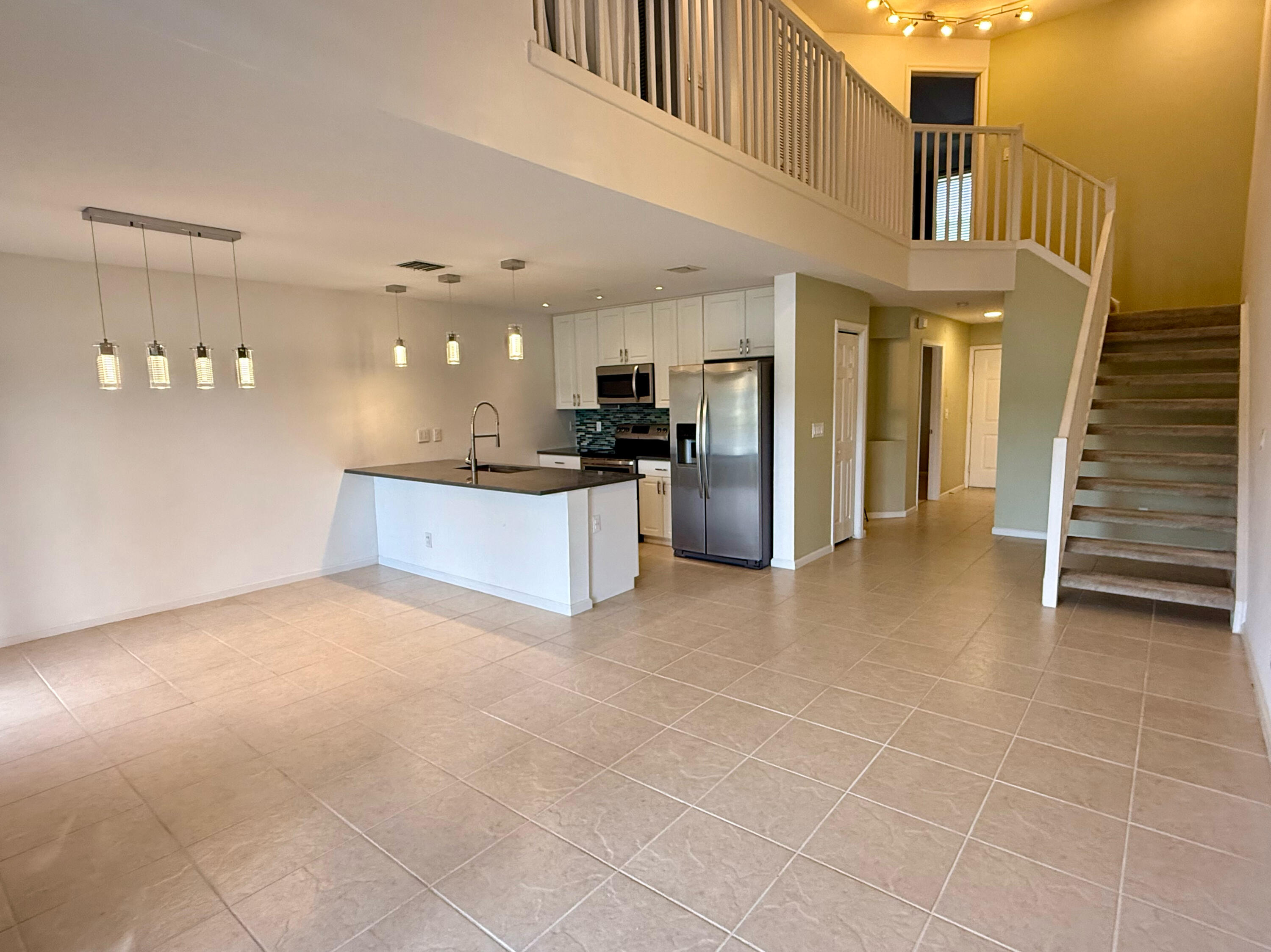 12813 Woodmill Drive Palm Beach Gardens, FL 33418 - Photo 4 of 30 a view of a kitchen with a sink and a refrigerator