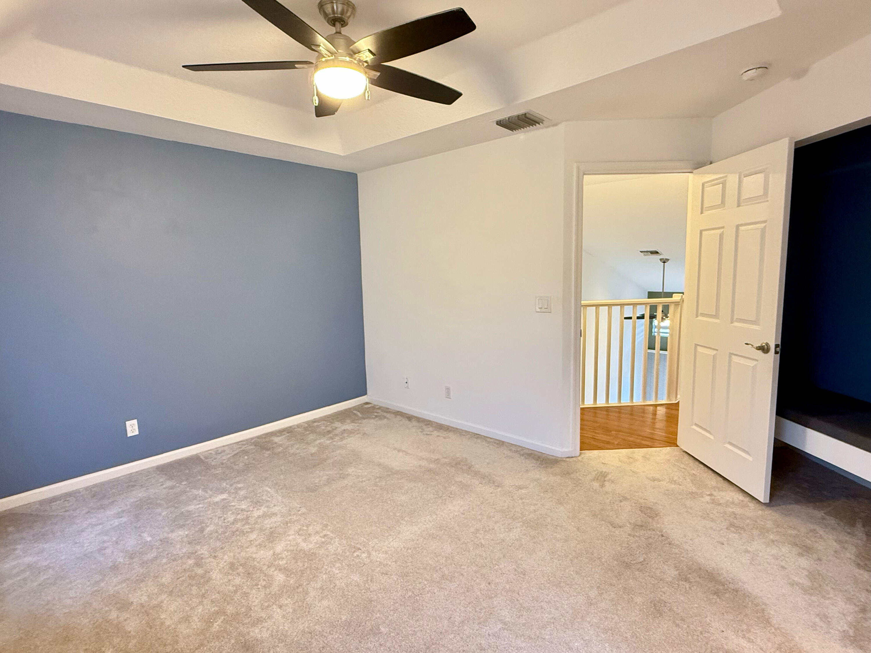 12813 Woodmill Drive Palm Beach Gardens, FL 33418 - Photo 8 of 30 an empty room with closet and a ceiling fan