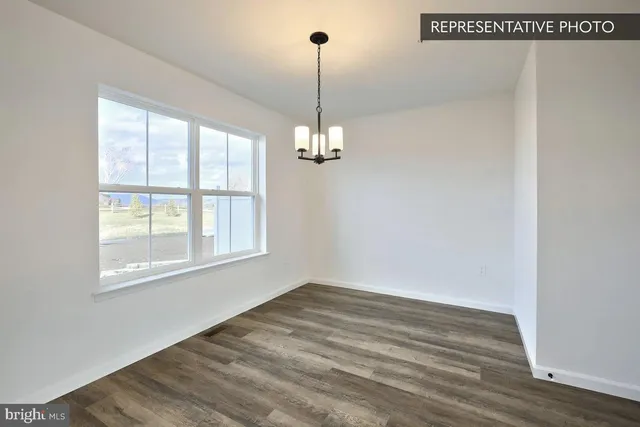 a view of a room with wooden floor and windows