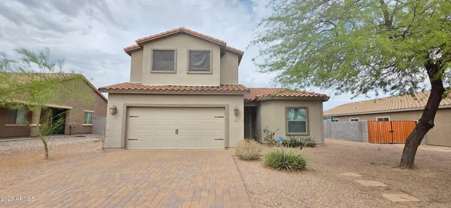 a front view of a house with a yard and garage