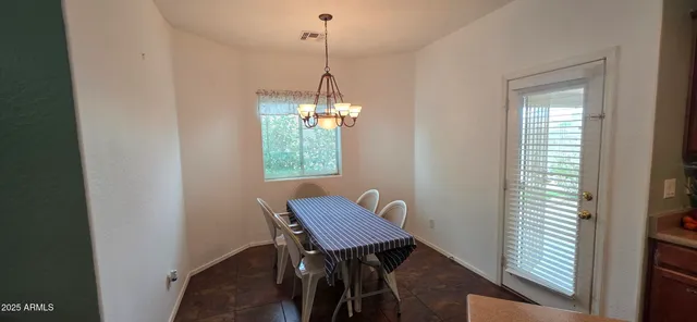 a view of a dining room with furniture and window