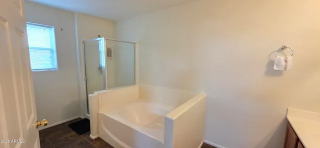 a bathroom with a tub and shower