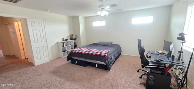 a bedroom with bed and window