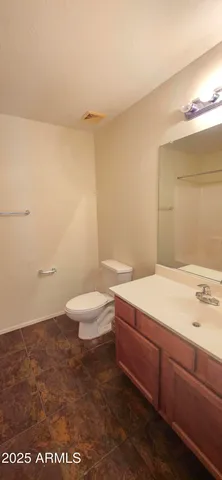 a bathroom with a sink a toilet and vanity