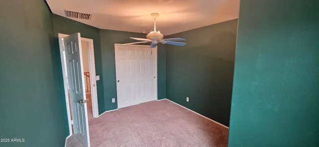 a view of a hallway with a chandelier fan