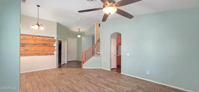 a view of a room with a ceiling fan and a window