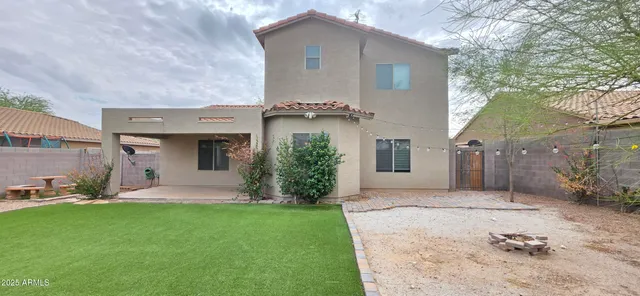 a view of a house with a yard and a garden